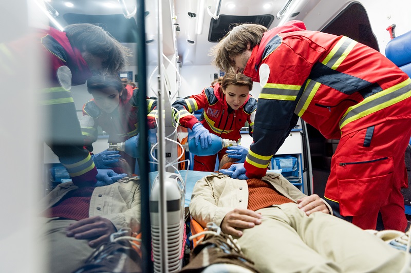Paramedics doing CPR in an ambulance after an accident