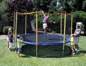 dad and kids enjoying a backyard trampoline