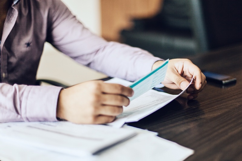 Person reviewing various documents