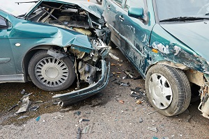 two severely damaged cars on a city street