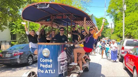 People Riding on a Pedal Pub