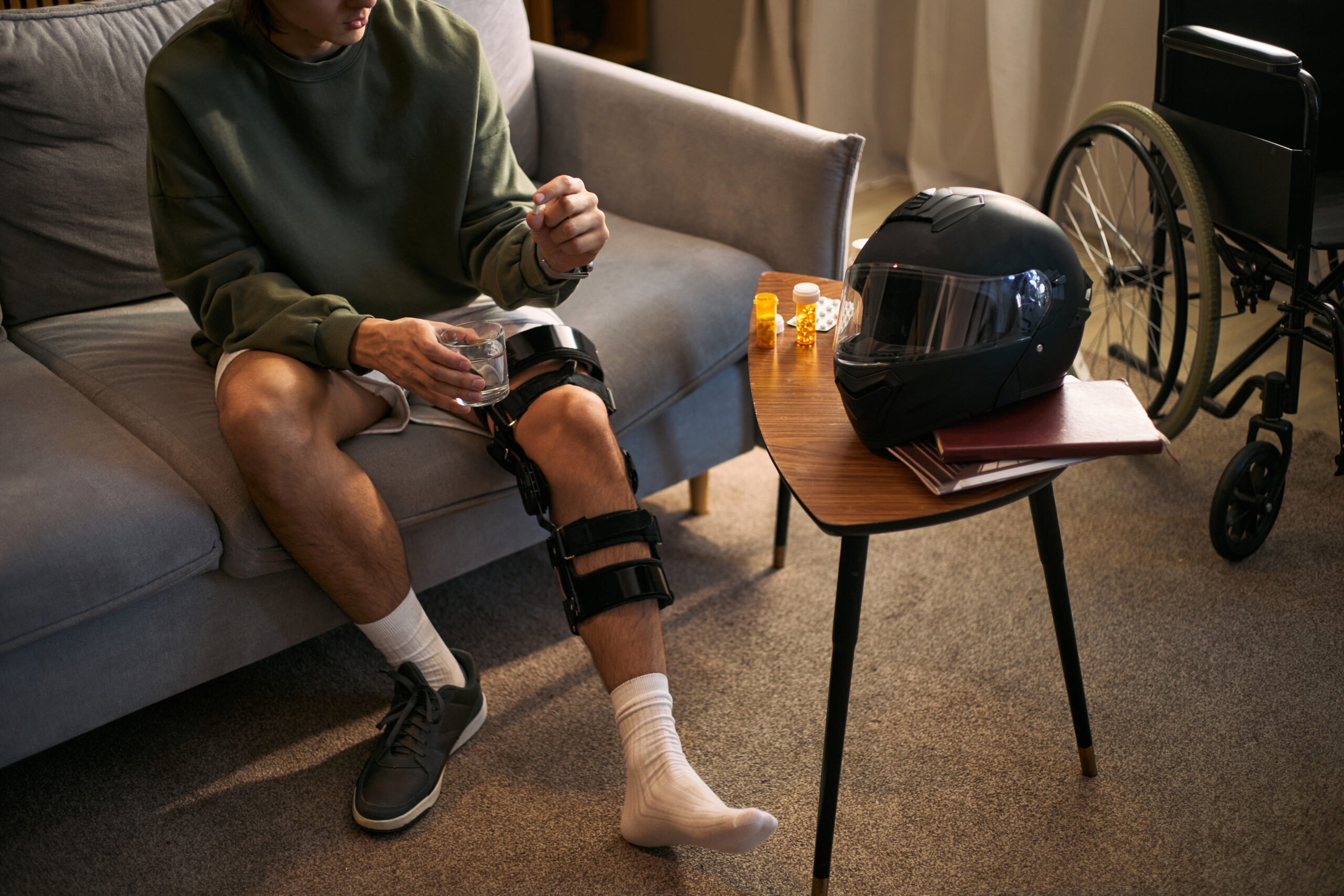 adult man recovering from leg injury with disability at home